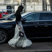 a woman wearing a Paco Rabanne evening gown at Paris Fashion Week street style FW23