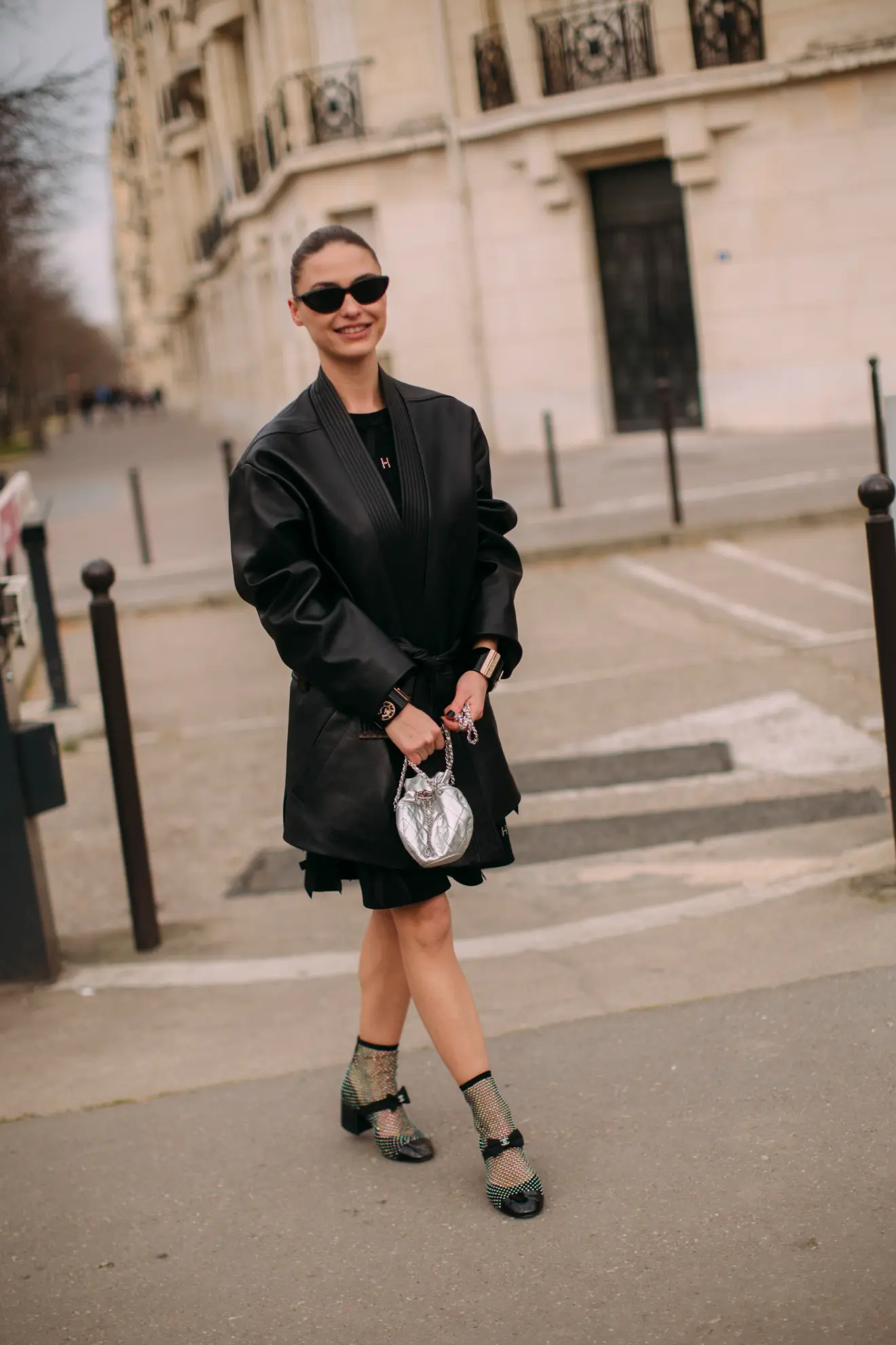 Parisian woman wearing a black little dress with Chanel block heel pumps