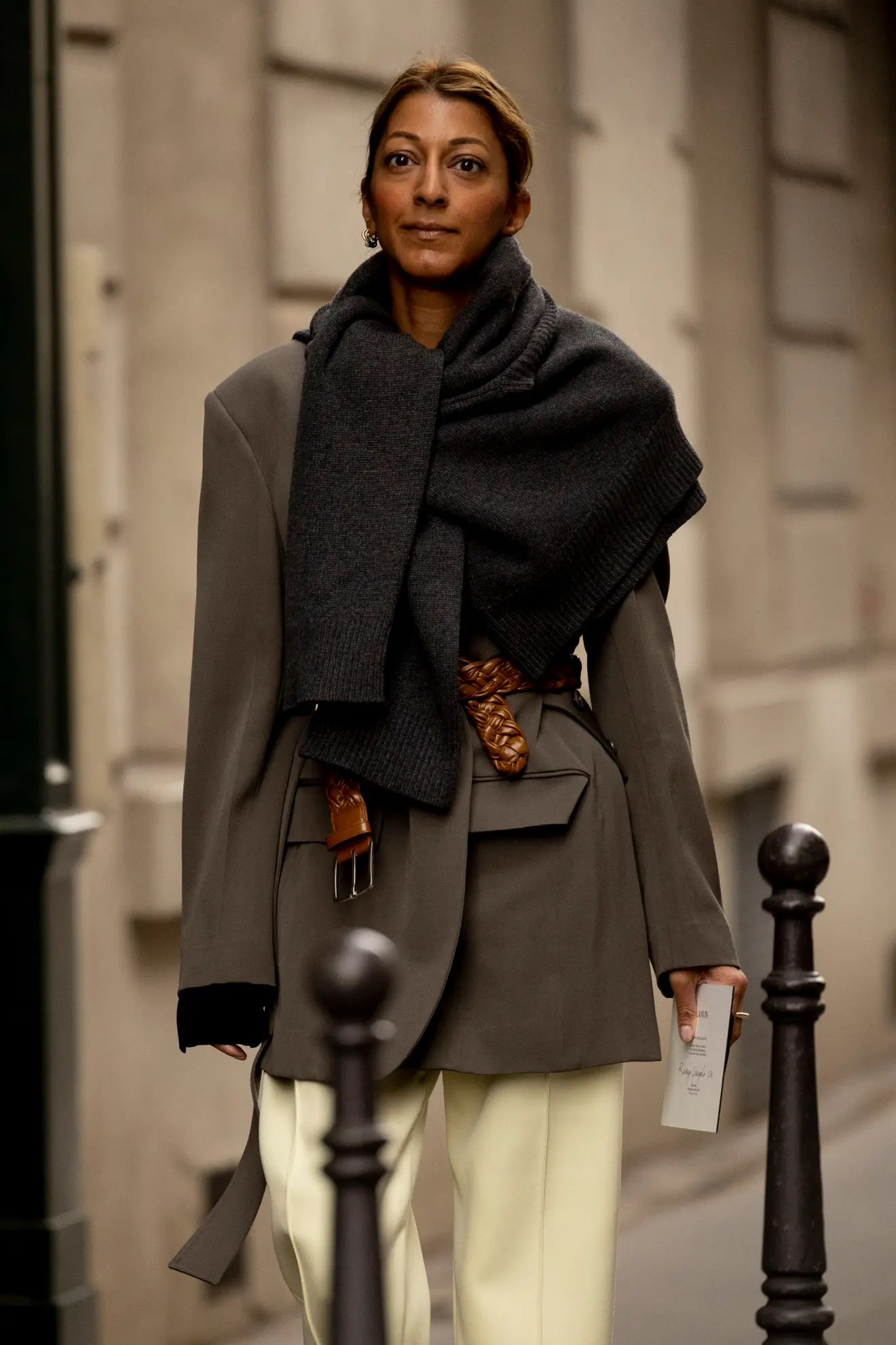 Parisian woman with masculine blazer with waist belt