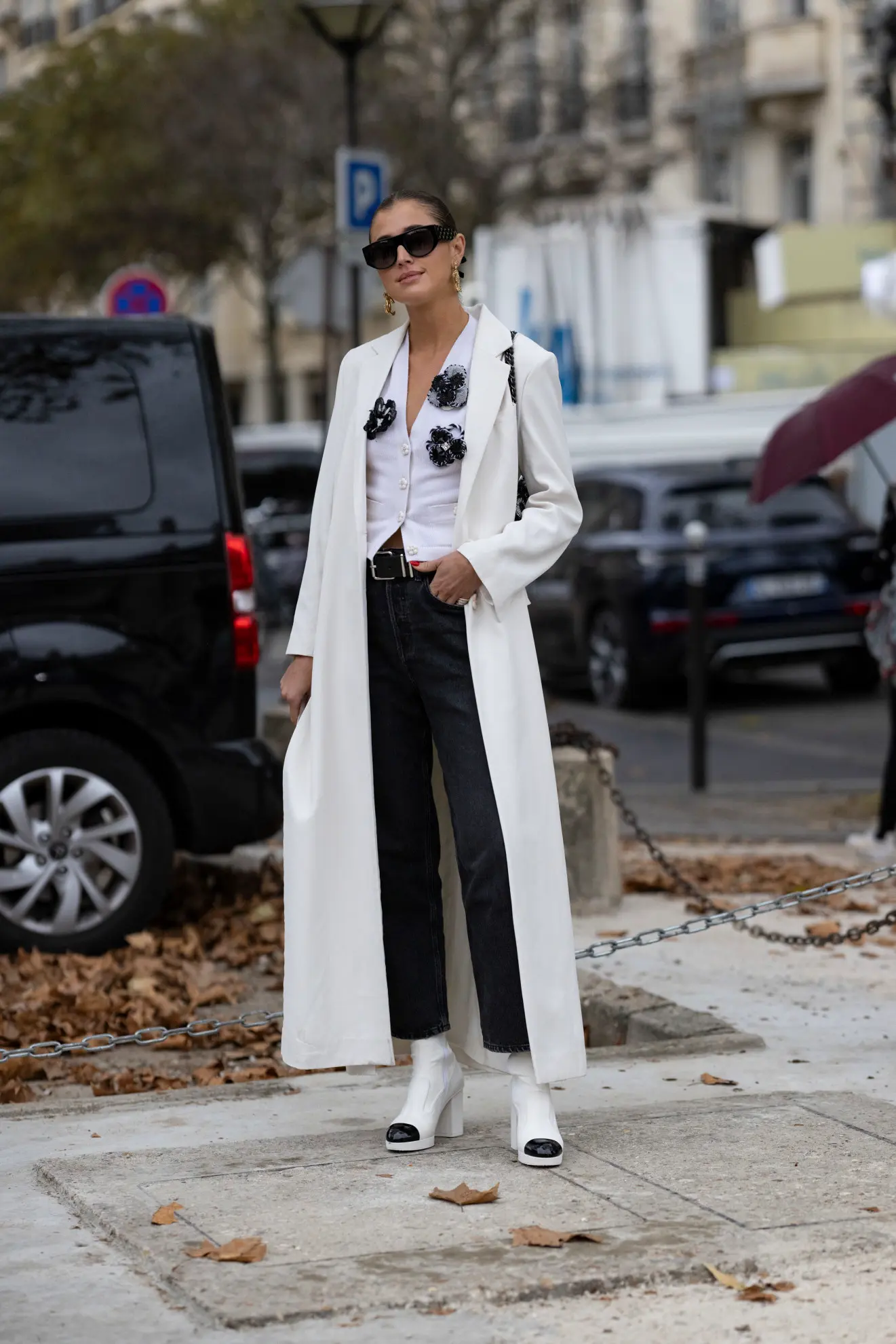 a woman at Paris fashion week wearing a black and white Chanel ensemble
