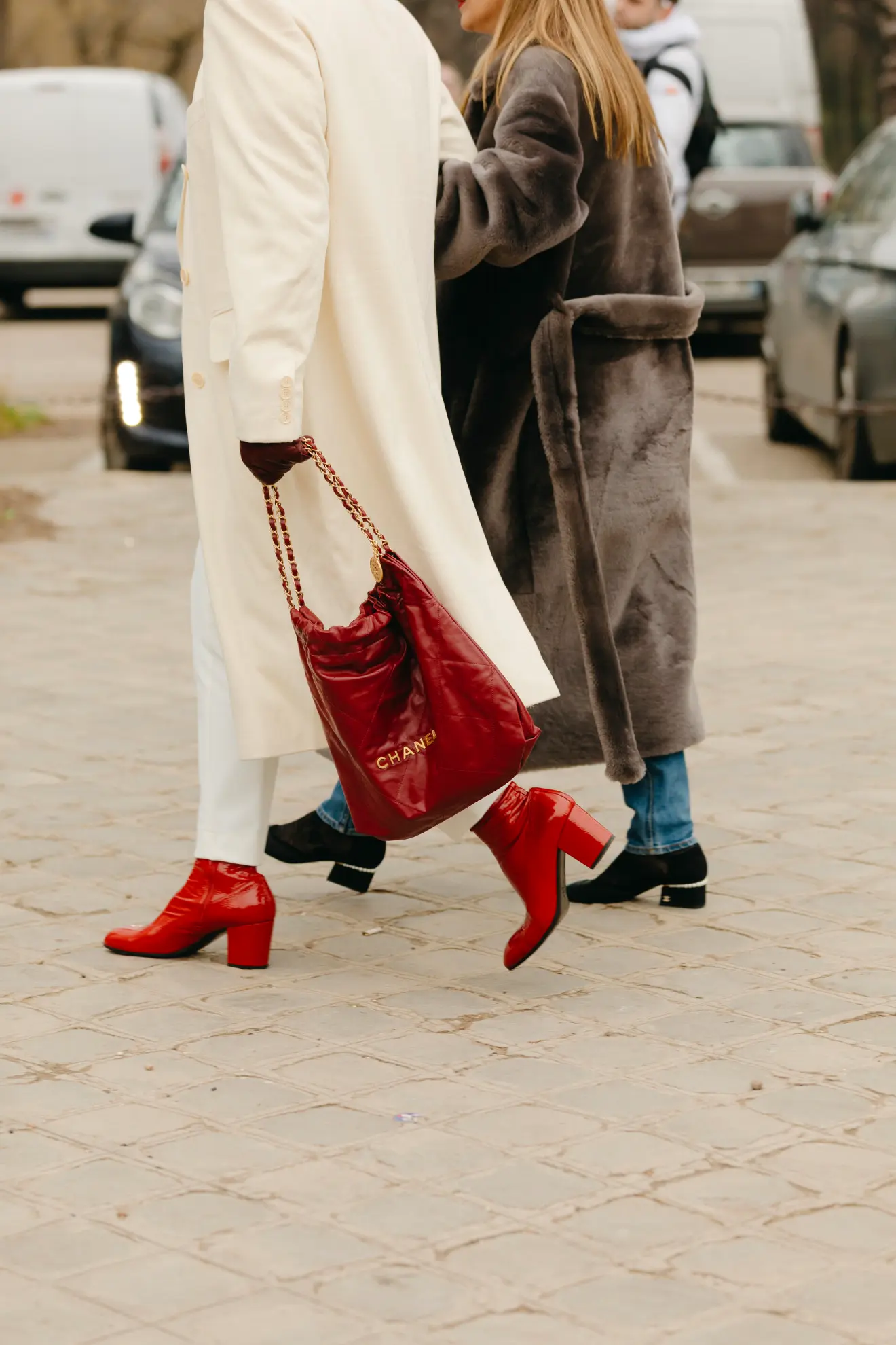 a woman wearing a pair of red patent leather shoes at Paris Fashion Week street style SS23